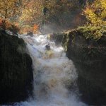 Photo of the Glenarm river in County Antrim Ireland. Pictures of Irish whitewater kayaking and canoeing. Andrew tucks up on the big one.. Photo by EoinH